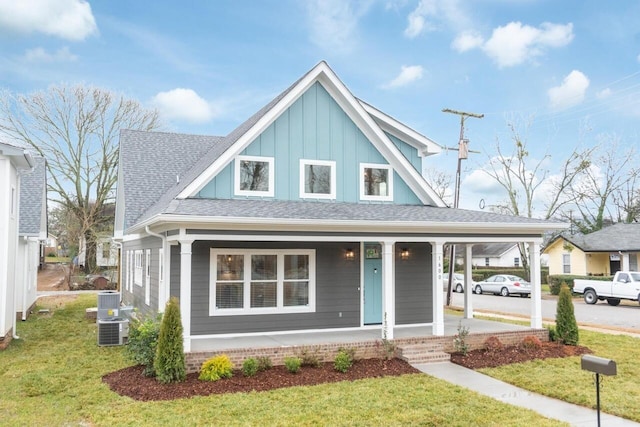 1600 Anderson Ave, Chattanooga, TN 37404 - view of front of home featuring covered porch, board and batten siding, a front lawn, and central AC