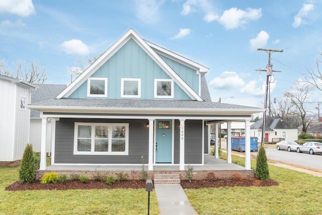 1600 Anderson Ave, Chattanooga, TN 37404 - view of front of property with covered porch, board and batten siding, a front lawn, and roof with shingles