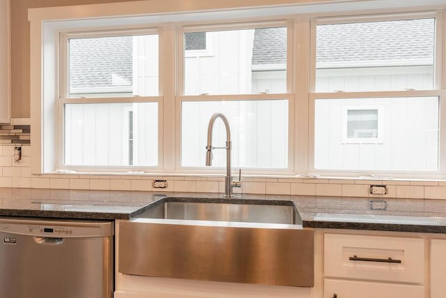 1600 Anderson Ave, Chattanooga, TN 37404 - kitchen with stainless steel dishwasher, a sink, decorative backsplash, and dark stone counters