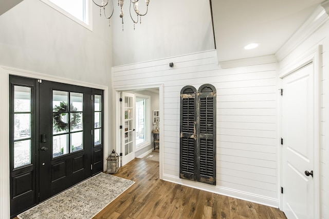 1078 Sunset Dr, Gallatin, TN 37066 - foyer with dark wood finished floors, a towering ceiling, a chandelier, wooden walls, and baseboards