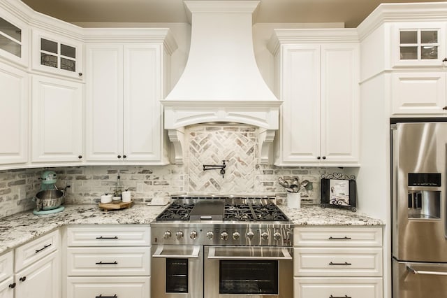 1078 Sunset Dr, Gallatin, TN 37066 - kitchen with stainless steel appliances, custom range hood, glass insert cabinets, and backsplash