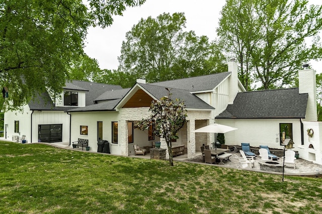 1078 Sunset Dr, Gallatin, TN 37066 - back of property featuring a patio, a lawn, board and batten siding, a chimney, and an outdoor living space with a fire pit