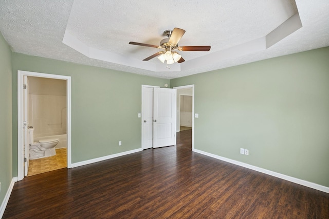 1006 Aretha Dr, Murfreesboro, TN 37128 - unfurnished bedroom featuring wood finished floors, a textured ceiling, baseboards, and a raised ceiling
