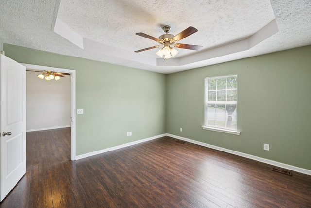 1006 Aretha Dr, Murfreesboro, TN 37128 - unfurnished room with a textured ceiling, a tray ceiling, wood finished floors, a ceiling fan, and baseboards