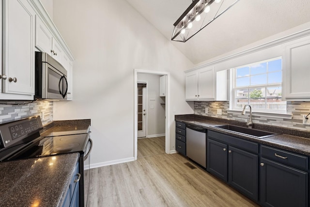1006 Aretha Dr, Murfreesboro, TN 37128 - kitchen featuring appliances with stainless steel finishes, a sink, white cabinets, tasteful backsplash, and high vaulted ceiling