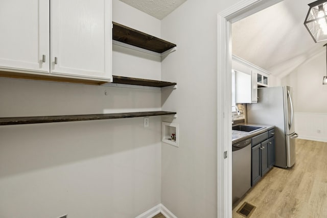 1006 Aretha Dr, Murfreesboro, TN 37128 - kitchen with open shelves, a sink, stainless steel appliances, white cabinets, and light wood-style floors