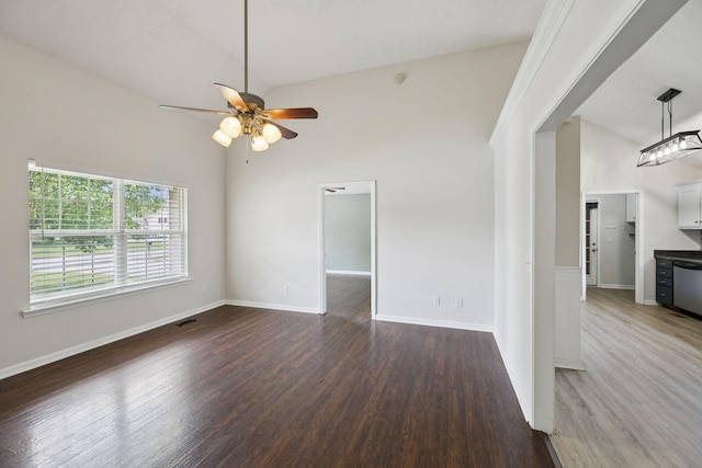 1006 Aretha Dr, Murfreesboro, TN 37128 - unfurnished living room featuring wood finished floors, a ceiling fan, baseboards, and high vaulted ceiling