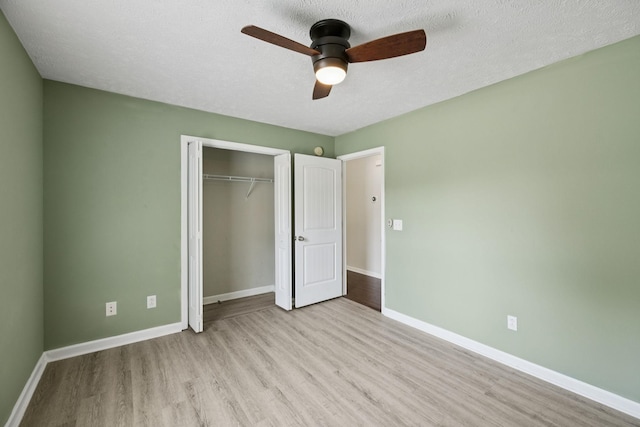 1006 Aretha Dr, Murfreesboro, TN 37128 - unfurnished bedroom featuring wood finished floors, a closet, baseboards, ceiling fan, and a textured ceiling