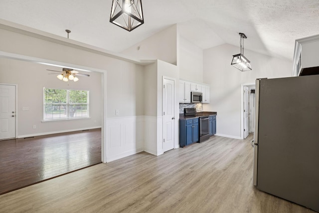 1006 Aretha Dr, Murfreesboro, TN 37128 - kitchen with appliances with stainless steel finishes, blue cabinets, a ceiling fan, light wood-type flooring, and pendant lighting