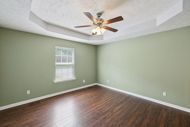 1006 Aretha Dr, Murfreesboro, TN 37128 - spare room featuring a textured ceiling, a tray ceiling, wood finished floors, and baseboards