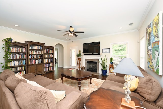146 Monarchos Dr, Gallatin, TN 37066 - living room featuring ceiling fan, arched walkways, wood finished floors, a fireplace with flush hearth, and ornamental molding