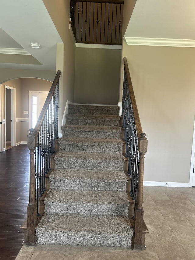 1370 Millet Dr, Clarksville, TN 37040 - staircase with arched walkways, baseboards, and crown molding