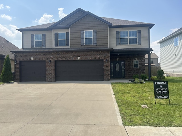 1370 Millet Dr, Clarksville, TN 37040 - view of front of house with an attached garage, concrete driveway, a front yard, and brick siding