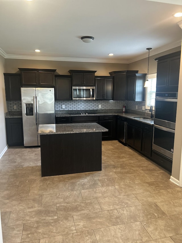 1370 Millet Dr, Clarksville, TN 37040 - kitchen featuring appliances with stainless steel finishes, dark stone counters, a center island, a sink, and tasteful backsplash