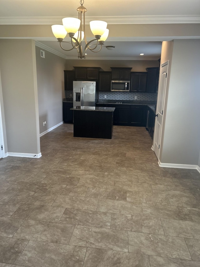 1370 Millet Dr, Clarksville, TN 37040 - kitchen featuring appliances with stainless steel finishes, a chandelier, a center island, backsplash, and baseboards