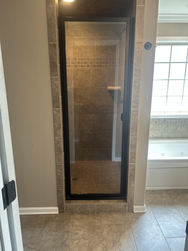 1370 Millet Dr, Clarksville, TN 37040 - bathroom with a shower stall, a jetted tub, baseboards, and tile patterned floors