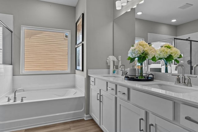 2884C Hamilton Ln, Lebanon, TN 37087 - bathroom featuring double vanity, a bath, a stall shower, and wood finished floors