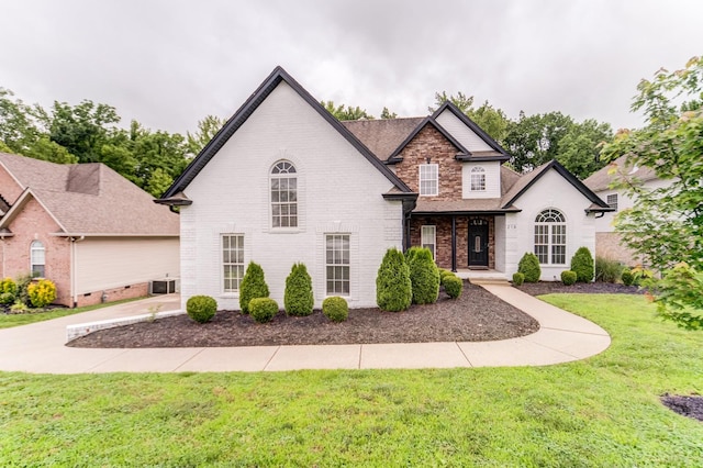 216 Artesa Dr, White House, TN 37188 - view of front facade featuring a front yard, brick siding, roof with shingles, and cooling unit