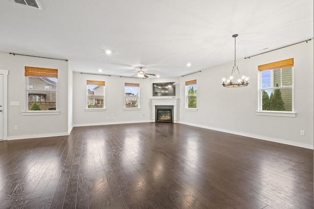 3368 Vinemont Dr, Thompsons Station, TN 37179 - unfurnished living room featuring ceiling fan, healthy amount of natural light, recessed lighting, a glass covered fireplace, and a chandelier