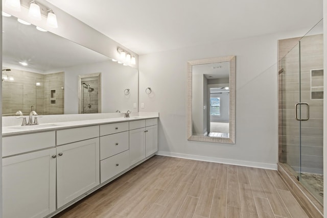 3368 Vinemont Dr, Thompsons Station, TN 37179 - bathroom featuring double vanity, a stall shower, wood finished floors, and baseboards