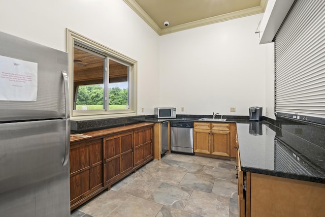 3368 Vinemont Dr, Thompsons Station, TN 37179 - kitchen featuring stainless steel appliances, crown molding, a sink, stone finish flooring, and dark stone counters