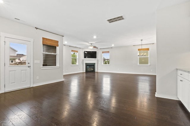 3368 Vinemont Dr, Thompsons Station, TN 37179 - unfurnished living room featuring a glass covered fireplace, baseboards, ceiling fan, dark wood-style flooring, and recessed lighting