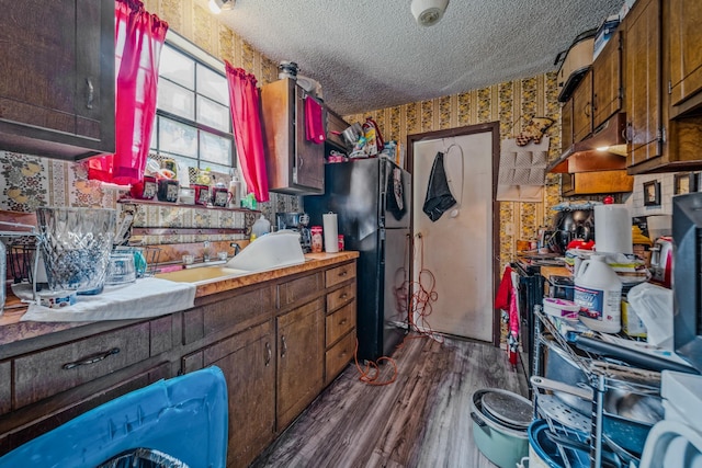 3846 Saunders Ave, Nashville, TN 37216 - kitchen with wallpapered walls, dark wood-style floors, freestanding refrigerator, a textured ceiling, and light countertops