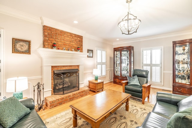1234 Windsor Dr, Gallatin, TN 37066 - living room with plenty of natural light, light wood-type flooring, ornamental molding, a fireplace, and a chandelier