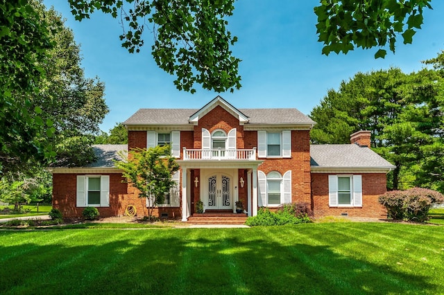 1234 Windsor Dr, Gallatin, TN 37066 - colonial house featuring french doors, brick siding, a front yard, a chimney, and a balcony