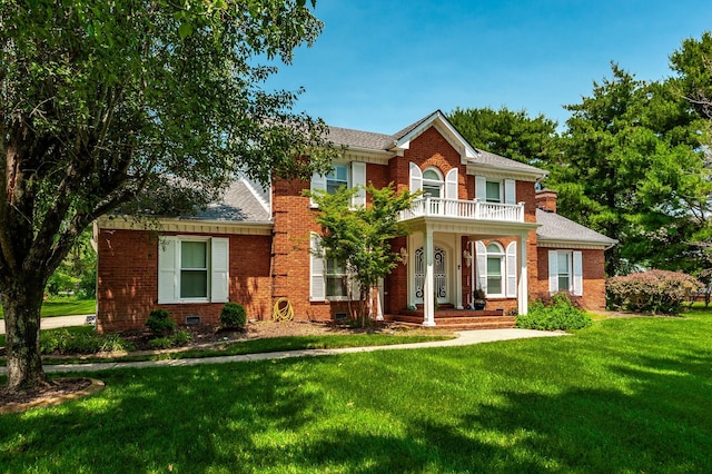 1234 Windsor Dr, Gallatin, TN 37066 - colonial home with a balcony, brick siding, a front lawn, and a shingled roof