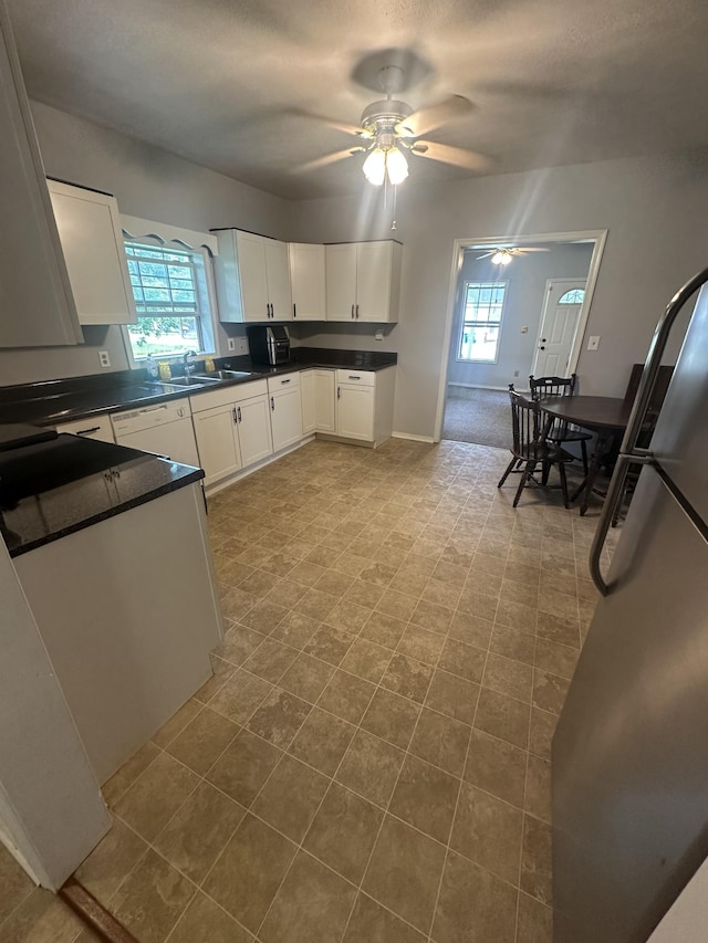 130 Post Oak Ave, Camden, TN 38320 - kitchen with dark countertops, a ceiling fan, white cabinets, and healthy amount of natural light