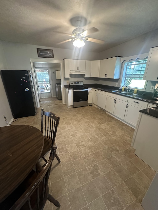 130 Post Oak Ave, Camden, TN 38320 - kitchen featuring stainless steel range with electric cooktop, a sink, a ceiling fan, white cabinets, and dark countertops
