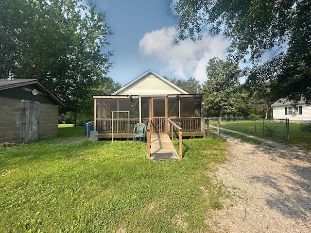 130 Post Oak Ave, Camden, TN 38320 - back of property with a sunroom and dirt driveway