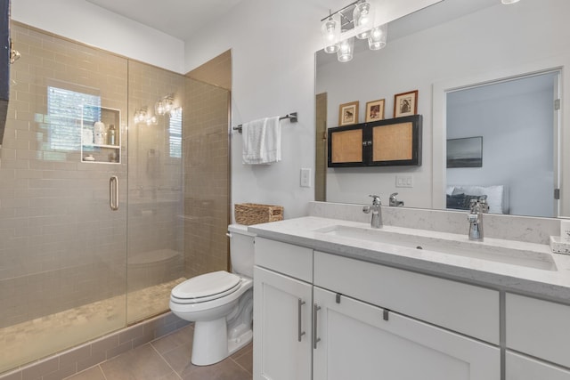 682 James Ave, Nashville, TN 37209 - bathroom featuring vanity, toilet, a stall shower, tile patterned flooring, and ensuite bathroom