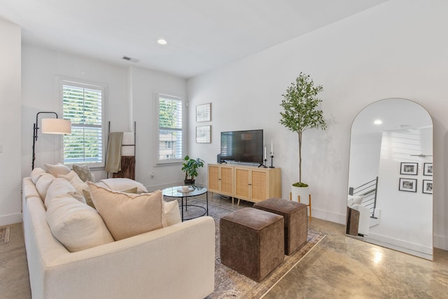 682 James Ave, Nashville, TN 37209 - living area with baseboards, finished concrete flooring, recessed lighting, stairs, and arched walkways
