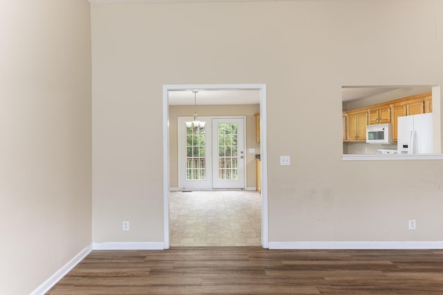 1036 Woodbrier Ln, Greenbrier, TN 37073 - unfurnished living room featuring a chandelier, dark wood finished floors, and baseboards