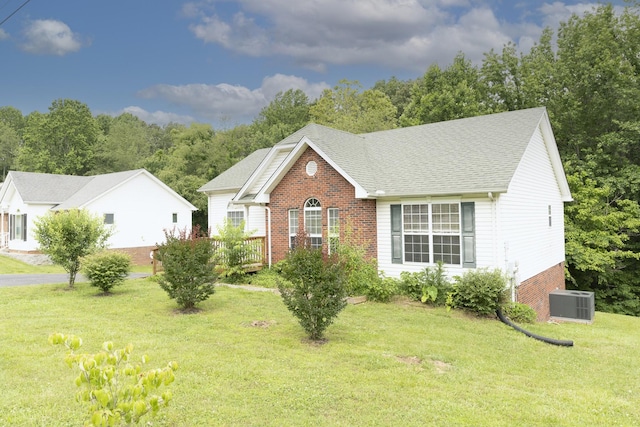 1036 Woodbrier Ln, Greenbrier, TN 37073 - view of front of property featuring brick siding, a front lawn, central AC unit, and a shingled roof
