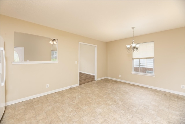 1036 Woodbrier Ln, Greenbrier, TN 37073 - empty room featuring a chandelier, tile patterned floors, and baseboards