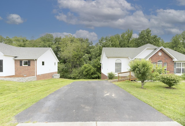 1036 Woodbrier Ln, Greenbrier, TN 37073 - view of side of home featuring brick siding, driveway, a lawn, and a deck