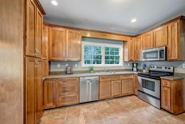 80 Latimer Cemetery Ln, Waverly, TN 37185 - kitchen featuring appliances with stainless steel finishes, a sink, light tile patterned flooring, brown cabinets, and recessed lighting