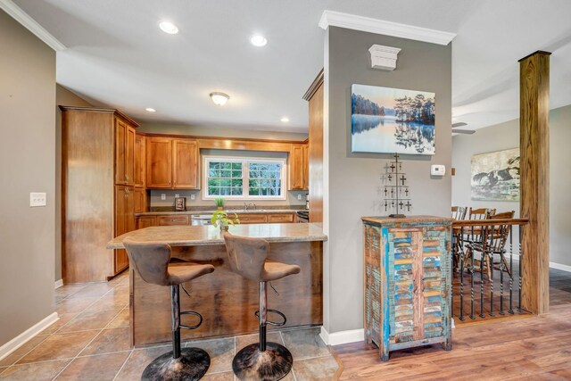 80 Latimer Cemetery Ln, Waverly, TN 37185 - kitchen with a sink, baseboards, ornamental molding, brown cabinetry, and recessed lighting