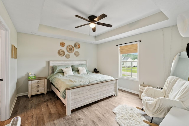 611 Annas Way, Lewisburg, TN 37091 - bedroom with a tray ceiling, baseboards, wood finished floors, and a ceiling fan