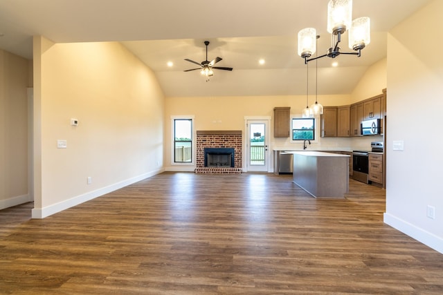 5359 Roy Holman Rd, Springfield, TN 37172 - kitchen with appliances with stainless steel finishes, open floor plan, vaulted ceiling, a chandelier, and a kitchen island