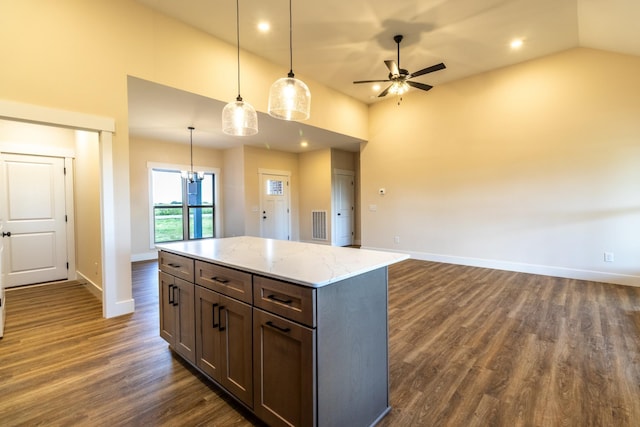 5359 Roy Holman Rd, Springfield, TN 37172 - kitchen featuring ceiling fan, baseboards, dark wood-style floors, light stone counters, and a kitchen island