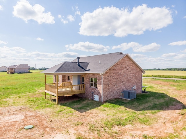 5359 Roy Holman Rd, Springfield, TN 37172 - rear view of house with brick siding, cooling unit, a deck, a yard, and a shingled roof