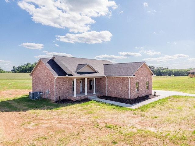 5359 Roy Holman Rd, Springfield, TN 37172 - view of front of home featuring a porch, brick siding, a front lawn, and central AC unit