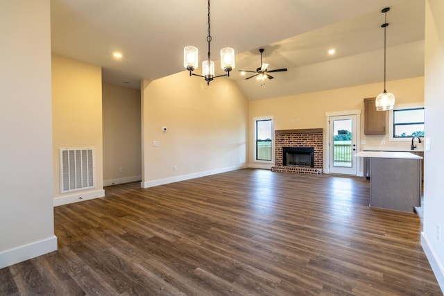 5359 Roy Holman Rd, Springfield, TN 37172 - unfurnished living room featuring baseboards, dark wood finished floors, a chandelier, and high vaulted ceiling