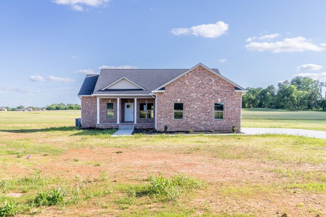 5359 Roy Holman Rd, Springfield, TN 37172 - view of front of property featuring a porch, brick siding, a front yard, and a shingled roof