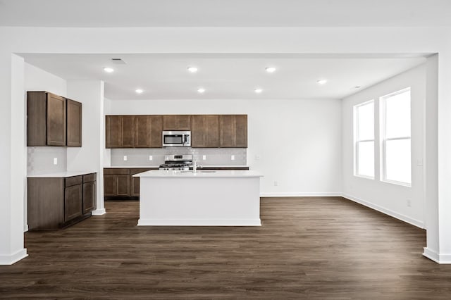 2278 Sutton Dr, White House, TN 37188 - kitchen with appliances with stainless steel finishes, dark wood finished floors, light countertops, and recessed lighting