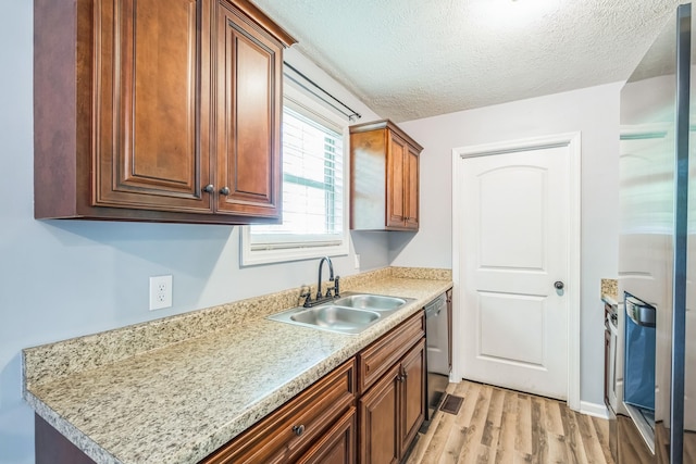 1435 Silver Creek Rd, Lewisburg, TN 37091 - kitchen featuring a sink, light wood-type flooring, a textured ceiling, stainless steel refrigerator with ice dispenser, and light countertops